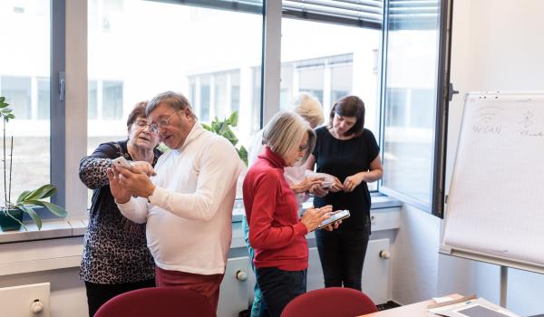 Senioren beschäftigen sich mit Smartphones und Tablets 